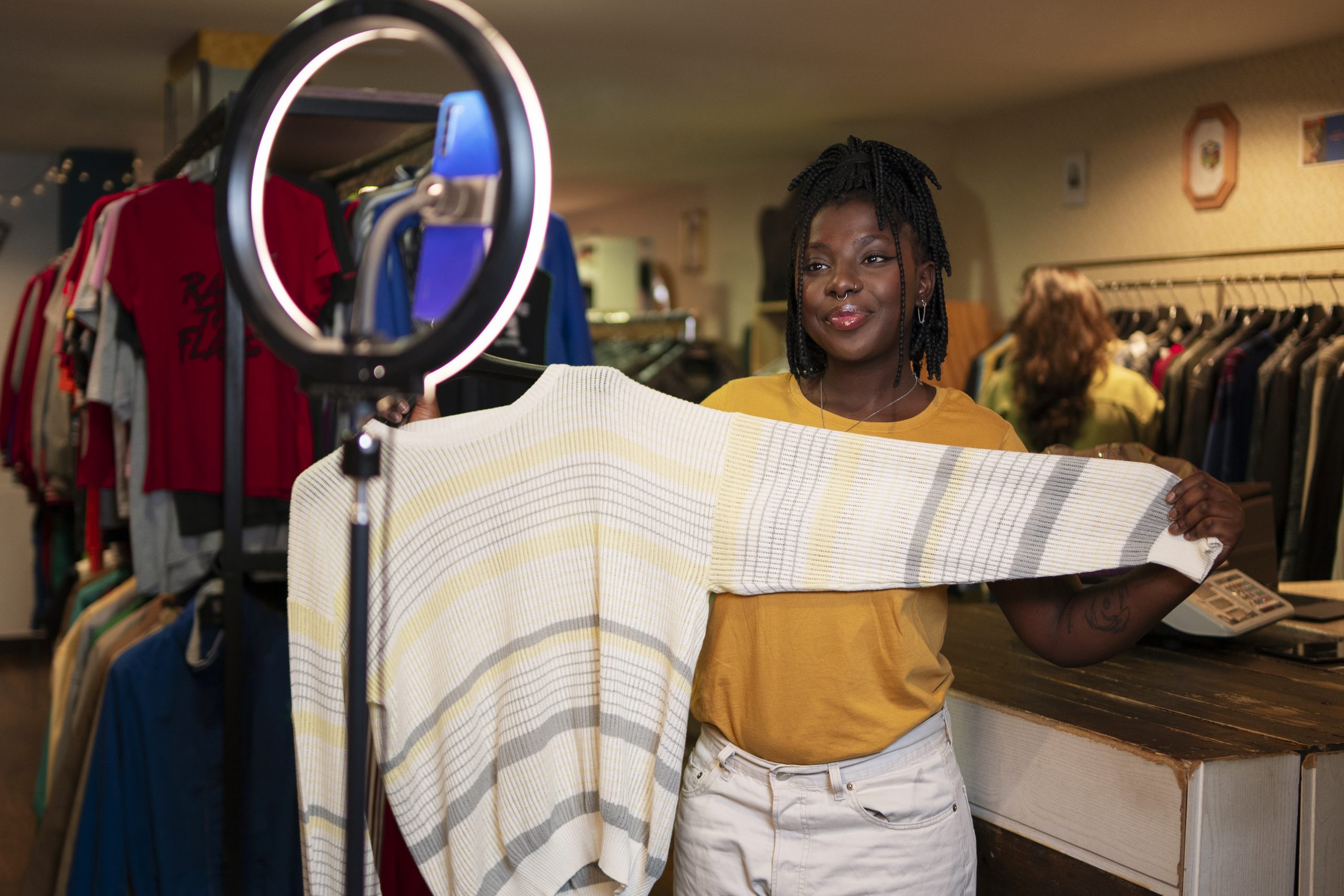 Accueil woman promoting cloths from thrift store